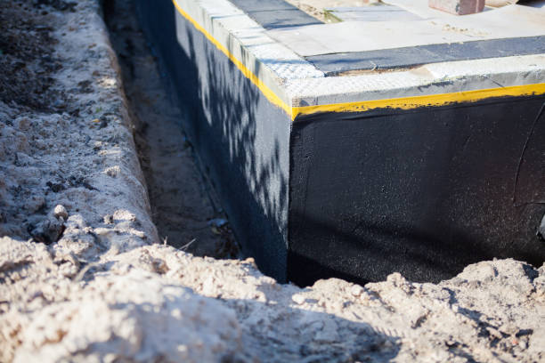 Professional Basement Waterproofing technician working in Kensington, NY